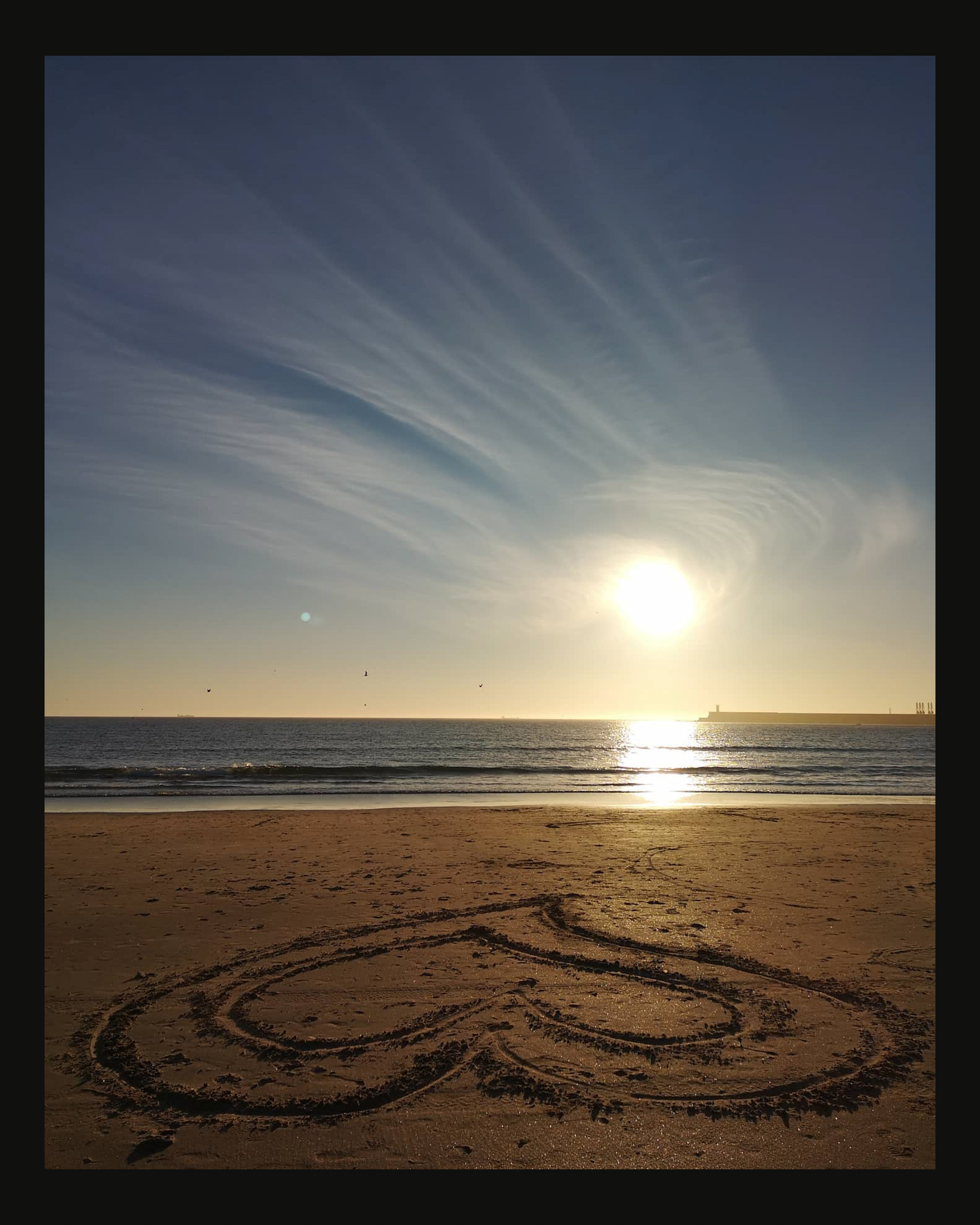 Heart drawn on Atlantic beach at sunset