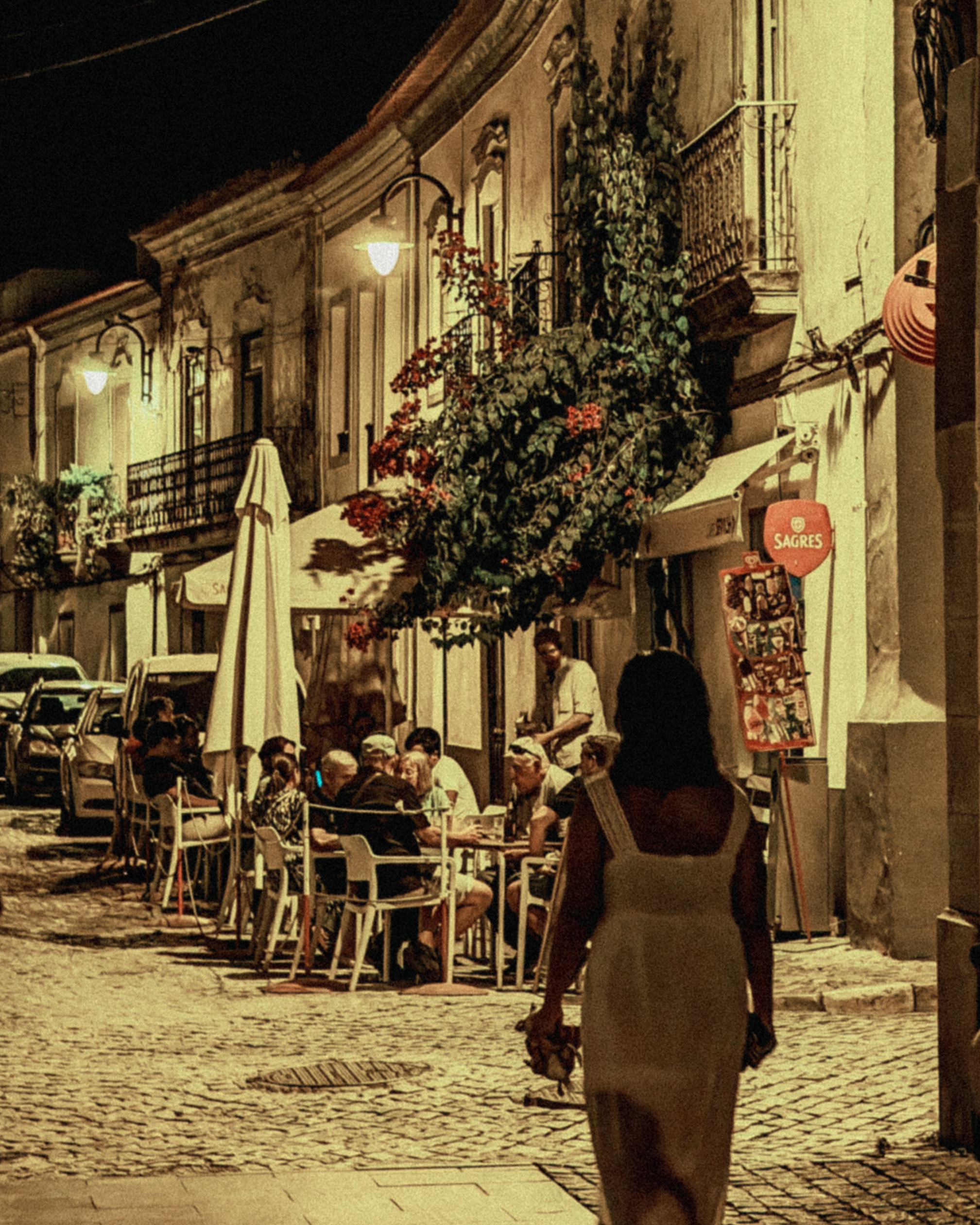 Historic cobblestone street terrace at night